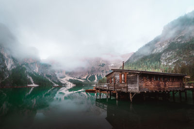 Scenic view of lake by mountains against sky