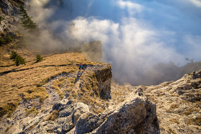 Woman jogging on mountain in foggy weather