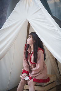 Woman sitting in tent