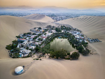 High angle view of beach against sky during sunset