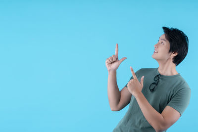 Woman standing against blue background