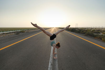 Rear view of woman walking on road