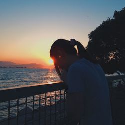 Silhouette of woman standing by sea