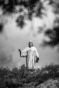 Statue of buddha on field