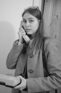 Portrait of beautiful young woman talking on telephone