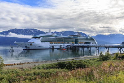 Scenic view of sea ship against sky and mountains