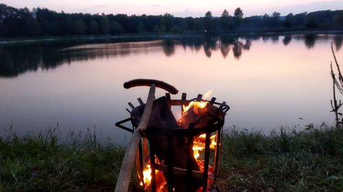 Reflection of fire on water in lake against sky