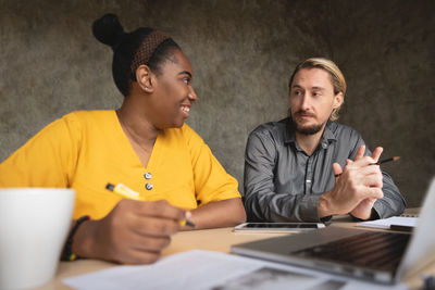 Man and woman discussing on table