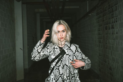 Portrait of woman standing in corridor