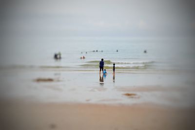 People on beach against sky