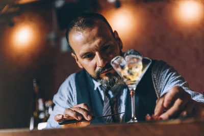 Bartender with drink on table at bar