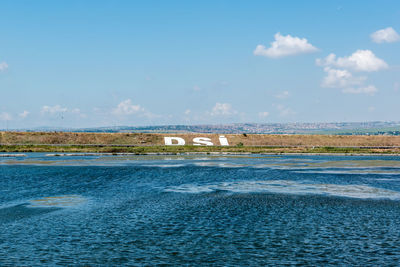 Bridge over sea against blue sky