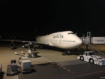 Airplane on airport runway at night