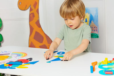 Boy drawing on paper at home