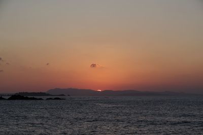 Scenic view of sea against orange sky