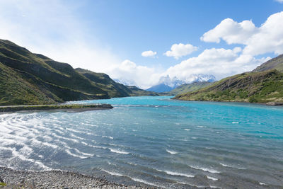 Scenic view of sea and mountains against sky