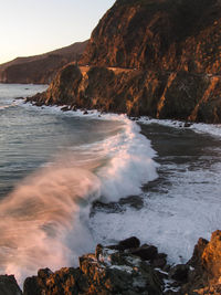Waves rushing towards cliff