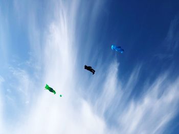 Low angle view of kite flying against blue sky