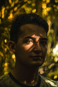 Portrait of confident young man in forest