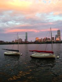 Boats in harbor at sunset