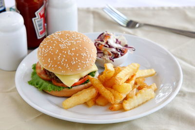 High angle view of hamburger and french fries in plate on table