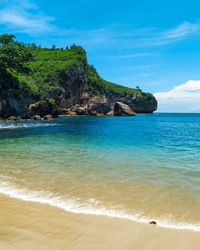 Scenic view of beach, blue sea, and blue sky