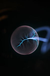 Close-up of crystal ball against black background