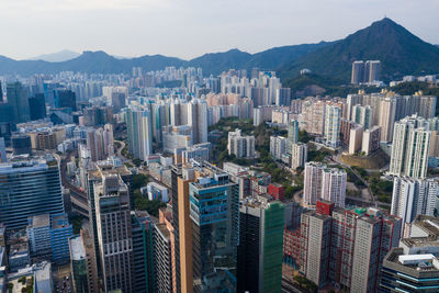 Aerial view of buildings in city against sky