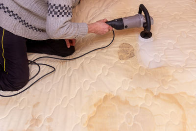 High angle view of woman hand on table at home