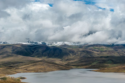 Scenic view of lake and mountains against sky