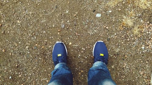 Low section of person standing on tiled floor