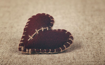 Close-up view of heart shape decor on burlap