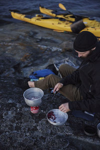 High angle view of tourist preparing food at sea