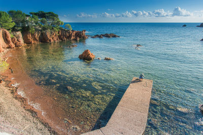 High angle view of rocks on sea against sky