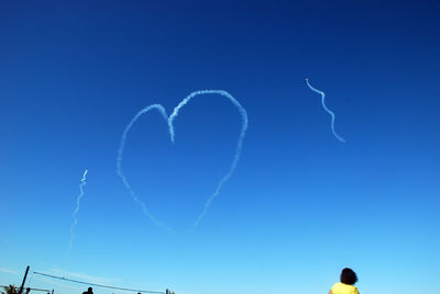 Low angle view of heart shape against blue sky