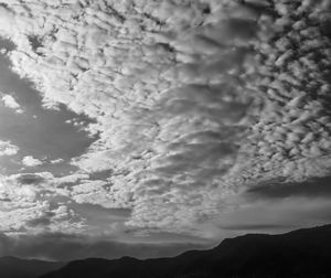 Low angle view of silhouette mountain against dramatic sky