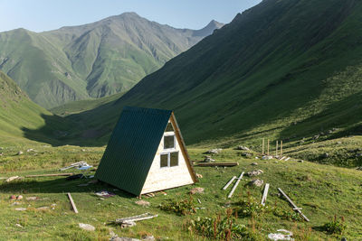 Scenic view of field and mountains against sky