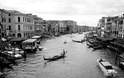 Grand canal amidst buildings in city against sky