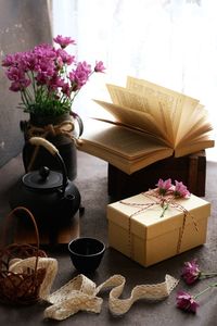 Present, flower,book, tea set beside the window