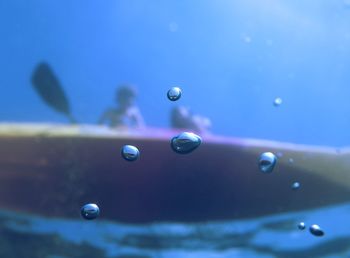 Close-up of bubbles against blue background