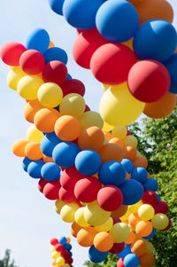 Low angle view of balloons against sky