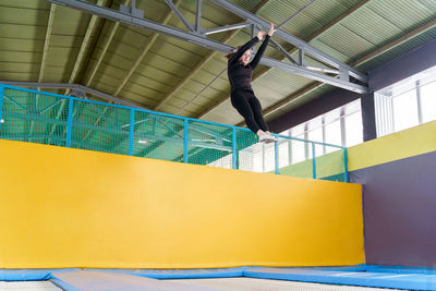 Low angle view of man skateboarding on ceiling