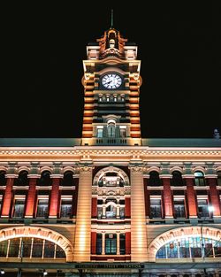 Low angle view of illuminated building against sky at night