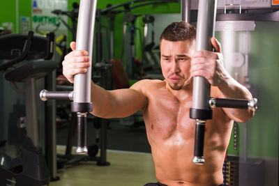 Midsection of shirtless man using mobile phone