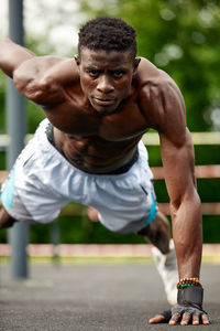 Portrait of young man exercising in gym