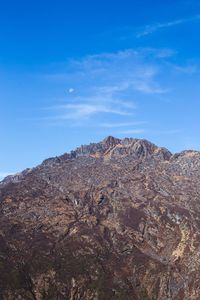 Scenic view of mountains against blue sky