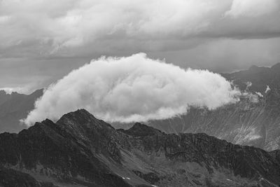 Scenic view of mountains against sky and clouds 