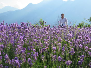 Woman standing on field against mountain