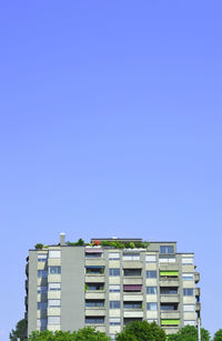 Low angle view of building against clear blue sky