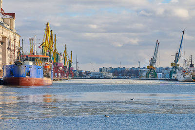 Moored cargo ships and harbor cranes in port. seaport, cargo container yard, container ship terminal